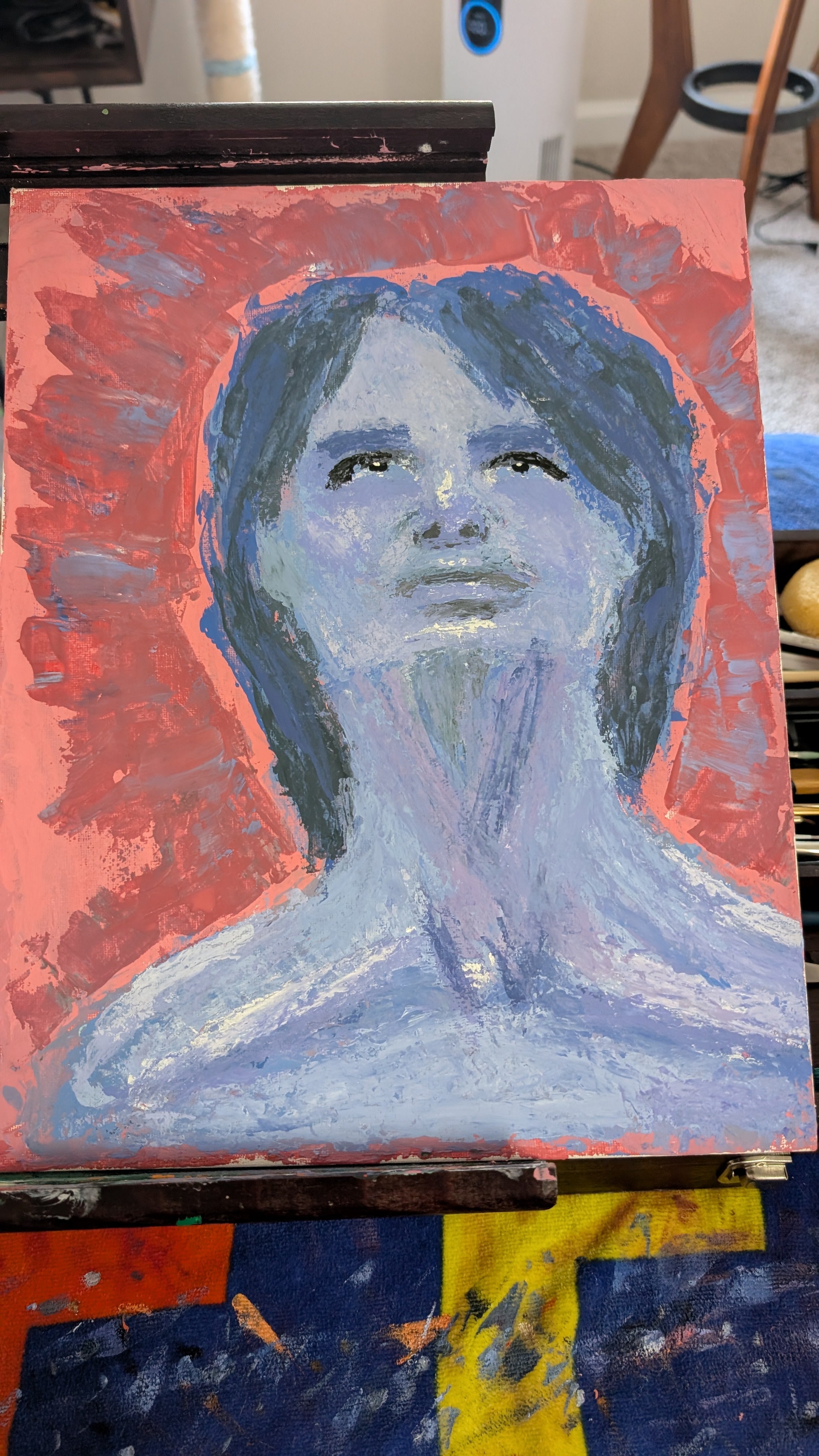Painting of a person with a red background on an easel
